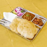 Chole Bhature · Pillowy 2 soft bhaturas steamed with chickpeas cooked in heartwarming masalas.