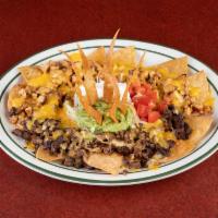 Nachos San Lorenzo · Fried corn tortillas topped with beans, choice of beef or chicken fajita and cheese, served ...