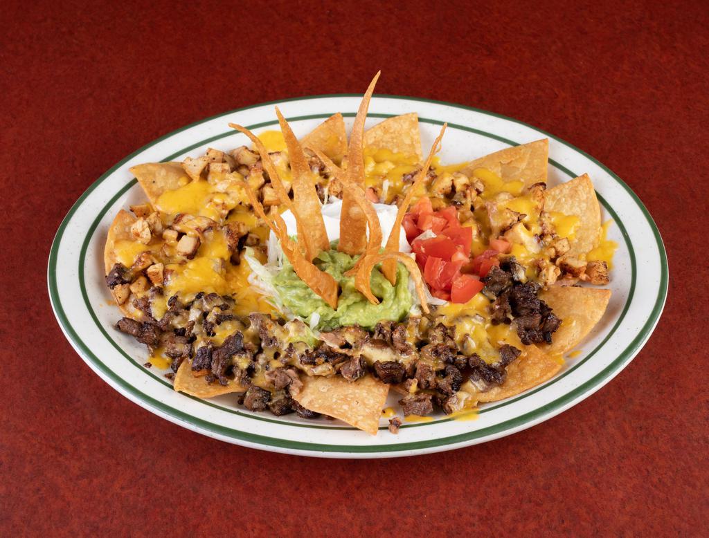Nachos San Lorenzo · Fried corn tortillas topped with beans, choice of beef or chicken fajita and cheese, served with lettuce, tomato, guacamole and sour cream.