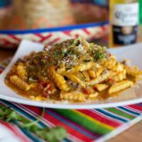 Smothered Hatch Green Chili Fries · Crispy golden french fries smothered with shredded cheese and Hatch green chili.