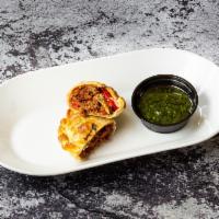 Yolanda Empanada · A delicious empanada filled with ground beef. Seasoned with onions, red bell peppers, manzan...