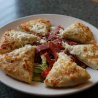 Gluten Free Pizza Chop Salad · Fresh chopped greens tossed with pepperoni, salami, roasted red peppers, black olives, bleu ...