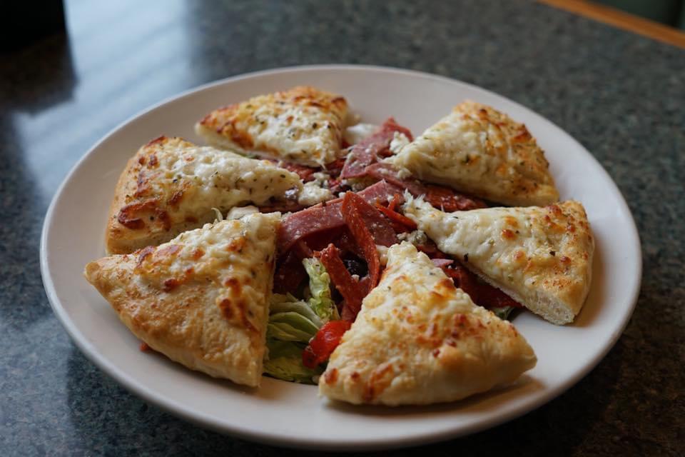 Gluten Free Pizza Chop Salad · Fresh chopped greens tossed with pepperoni, salami, roasted red peppers, black olives, bleu cheese crumbles & our house Italian dressing. Served with an 8
