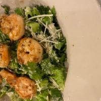 Gluten Free Shrimp Caesar Salad · Shrimp & croutons served on a bed of romaine & topped with parmesan cheese with Caesar dress...