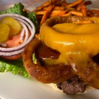 Rodeo Burger   · Slathered with BBQ sauce & topped with onion rings & cheddar cheese. Comes with lettuce, tom...