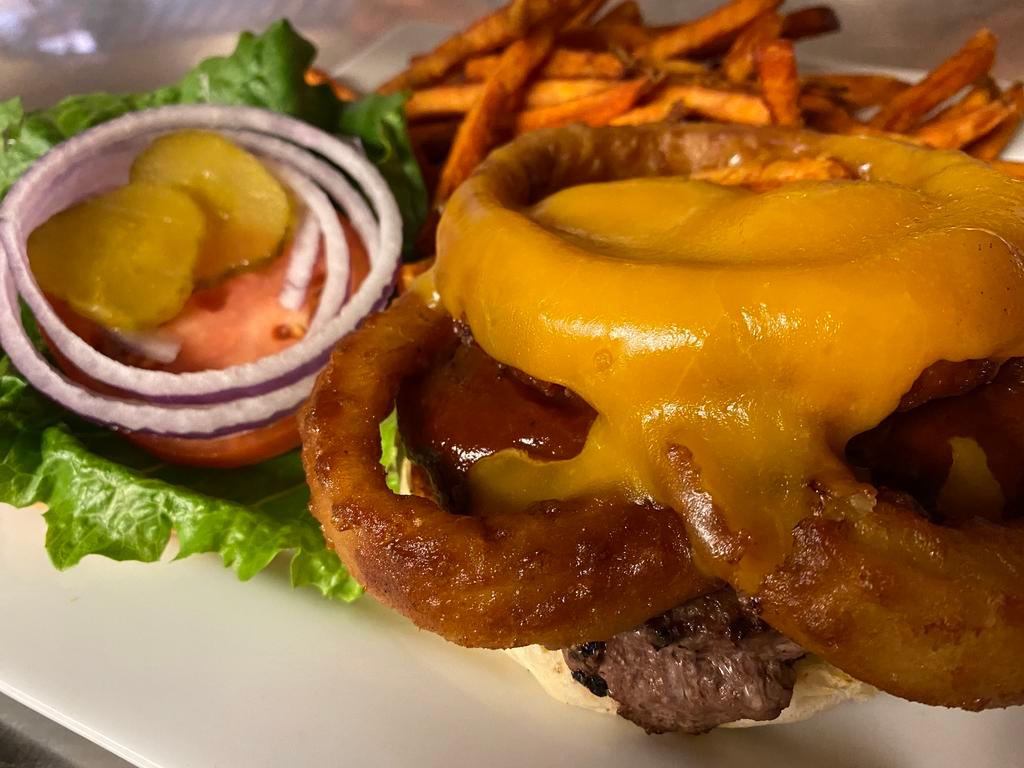 Rodeo Burger   · Slathered with BBQ sauce & topped with onion rings & cheddar cheese. Comes with lettuce, tomato & onion.. 