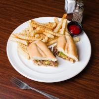 Philly Cheese Steak Sandwich · On a roll with french fries.