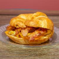 Buttery Croissant Bacon Breakfast Sandwich  · This sandwich is made with 3 slices of bacon, 2 eggs, and American cheese on a buttery crois...