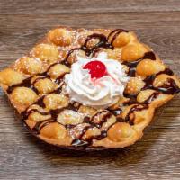 The Saucy Bubble Waffle · Fresh bubble waffle made with your choice of 1 sauce, whipped cream and cherry. Not served w...