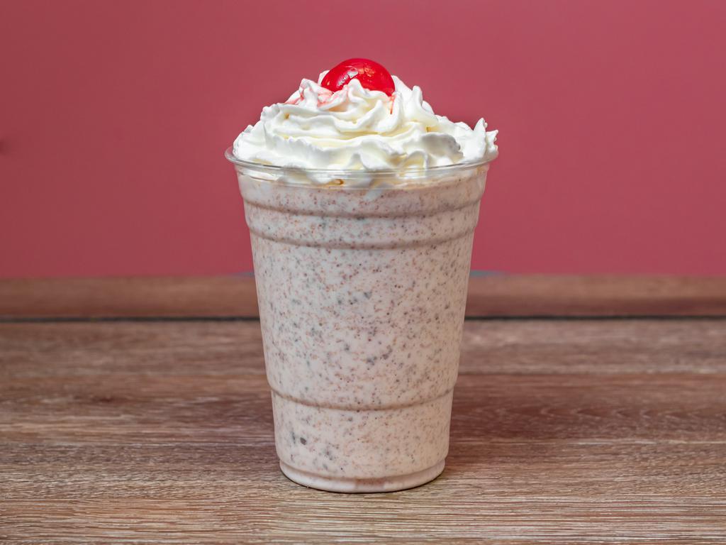Reese's Butter Cup Ice Cream Malt · Ice cream malt made with Reeses pieces, topped with whipped cream and cherry.
