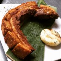 Chicharron con Arepa · Fried pork rind with corn cake.