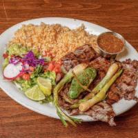 Carne Asada Plate · Marinated skirt steak charbroiled to perfection served with rice, refried beans, fresh guaca...