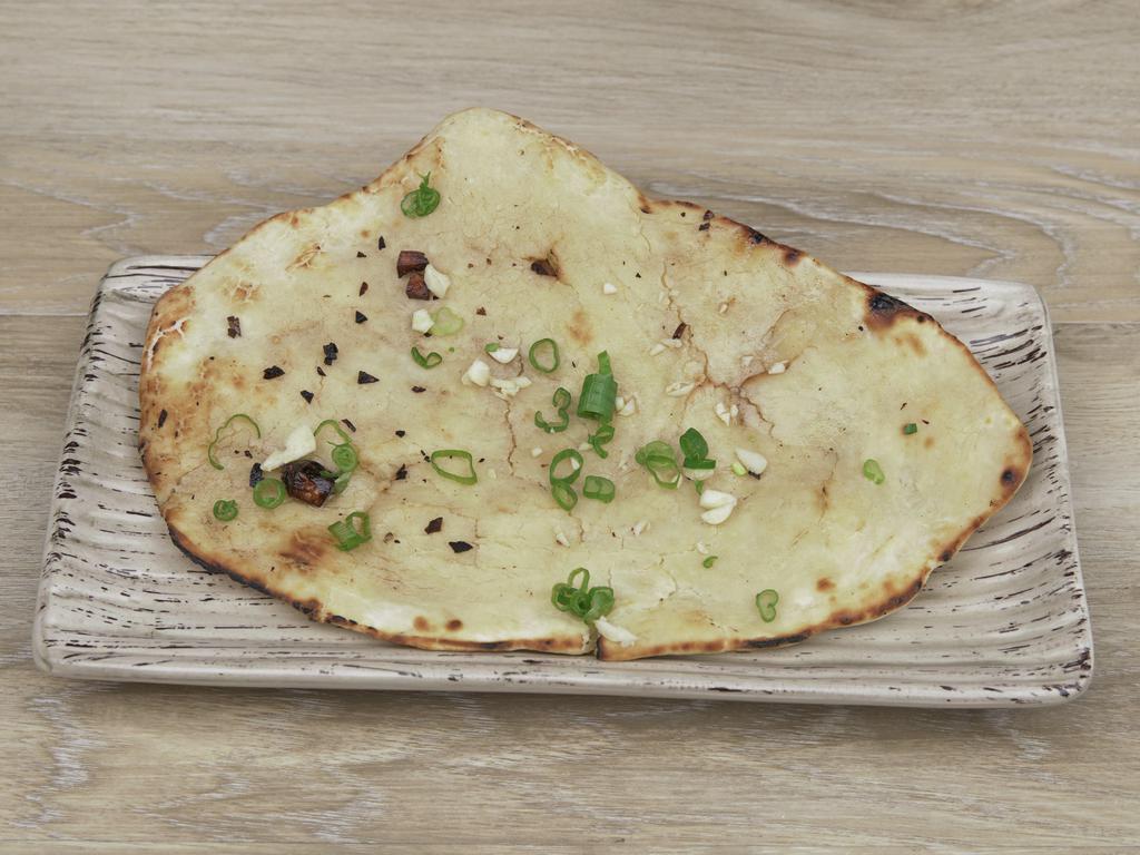Garlic Naan · Oven baked flatbread.