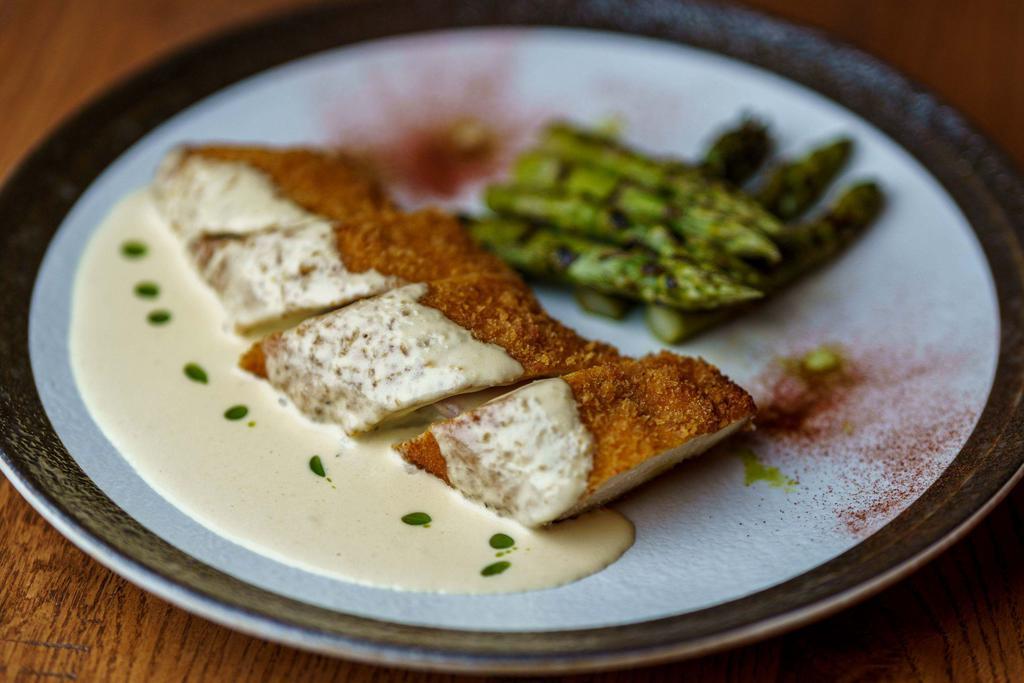 Chicken Cordon Bleu  · Chicken breast rolled with Ham and cheese. Served with asparagus, and Dijon creamy sauce. 