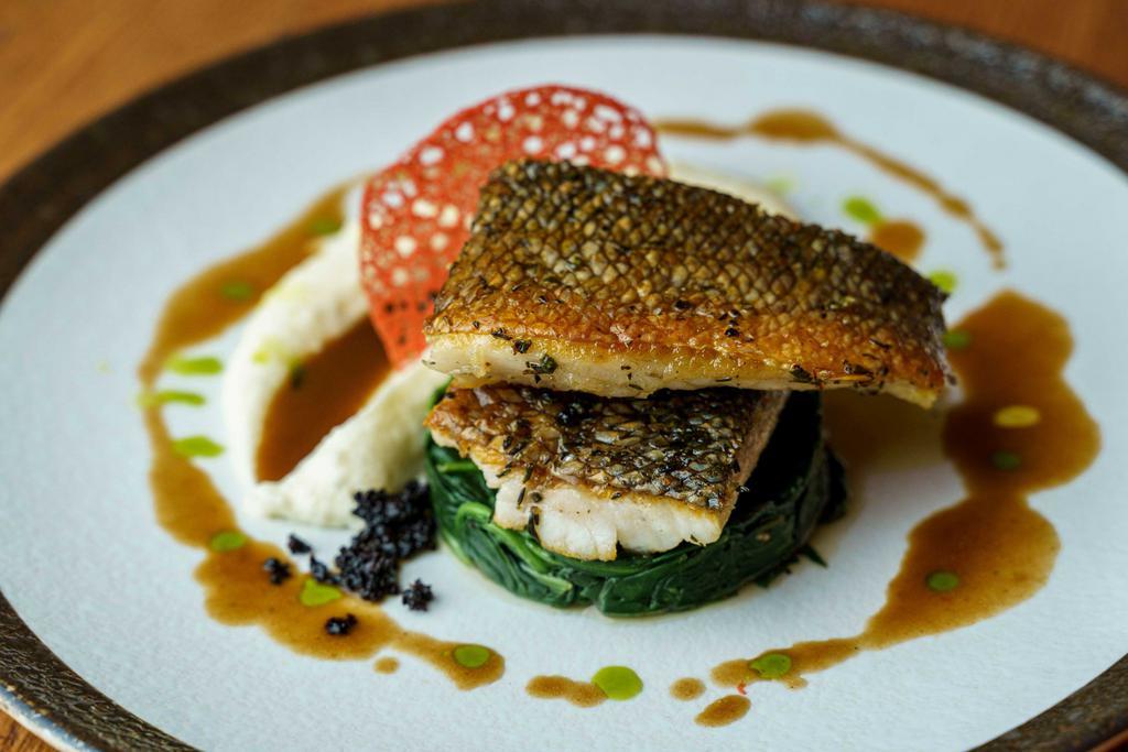 Seabass · Fillet of Mediterreanean  sea bass served with a pure of mash potato, sauteed baby spinach with red wine jus