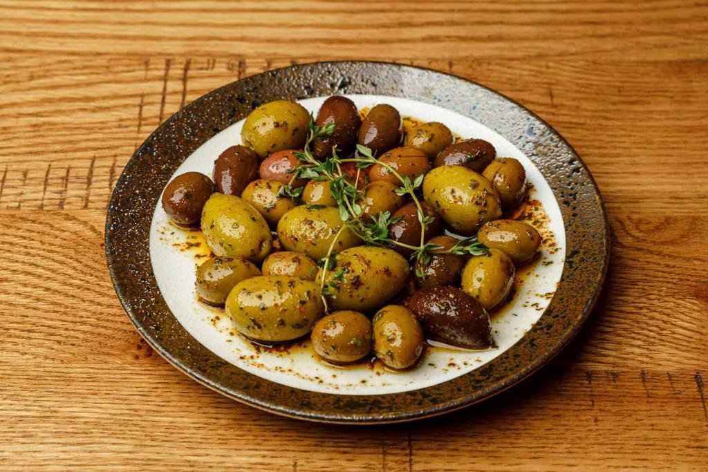 Marinated Olives  · Mixed olives marinated with olive oil, lemon , & herbs

