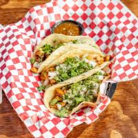 Street Tacos · 3 soft corn tortillas topped with lime, diced onions and cilantro. Served with roasted tomat...