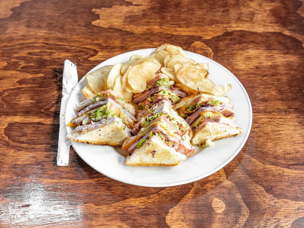 Classic Club Sandwich · Ham, turkey, bacon, cheddar cheese, Swiss cheese, lettuce, tomatoes, onion with sliced avocado on Texas toast.