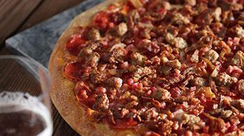 Butcher Shop Pizza · Served with our signature pizza sauce, cheese blend, pepperoni, ham, bacon, meatballs and sa...