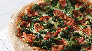 New York White Pizza · Served with garlic butter sauce, cheese blend, broccoli, spinach and tomatoes.