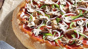 Veggie Deluxe Pizza · Served with our signature pizza sauce, cheese blend, mushrooms, green peppers, red onions, b...