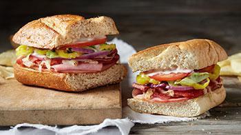 Italian Sub · Loaded with ham, salami, pepperoni, red onion, banana peppers, Wisconsin cheese blend, lettuce, tomatoes and creamy Italian dressing.