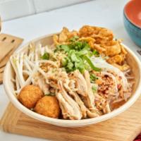 Tom Yum Noodle Soup · Rice noodle, pulled chicken, crispy fish balls, bean sprout, peanut, cilantro, scallion, won...