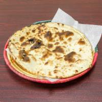 Naan · Soft leavened white bread cooked in a clay oven.