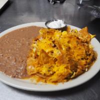 Chilaquiles Combo · Made with fried and crispy corn tortilla, topped with egg and chicken, onions, cheddar chees...