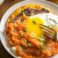 Huevos Ranchero Combo · 2 eggs sunny side up on top of a fried corn tortilla bathed in ranchero sauce, accompanied b...