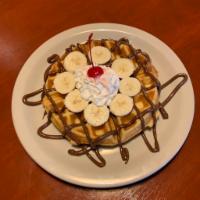 Nutella Waffle · A golden Belgian waffle with banana and Nutella, and whipped cream.