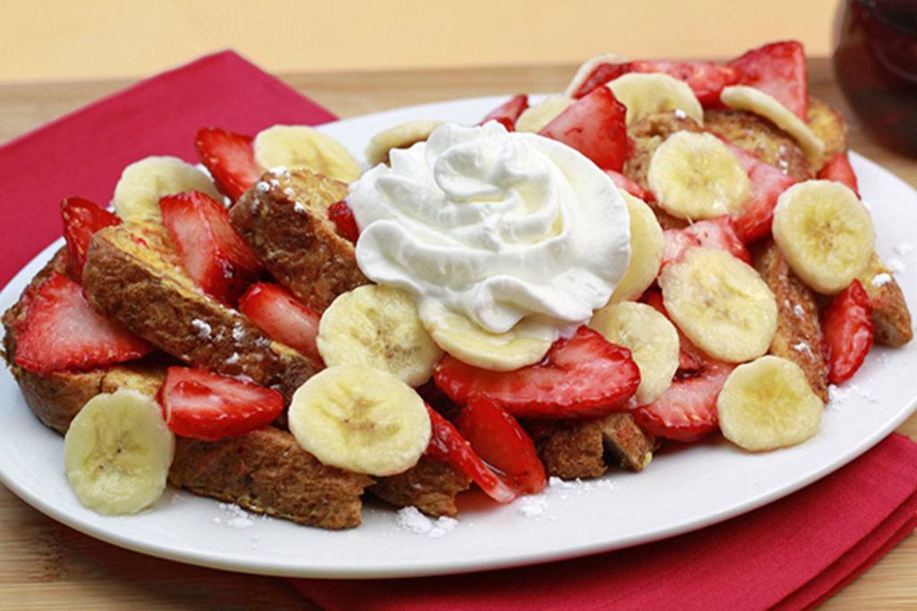 French Toast · 6 slices of fabulous french toast. Served with powdered sugar and whipped cream. Add bananas and strawberries for an additional charge.