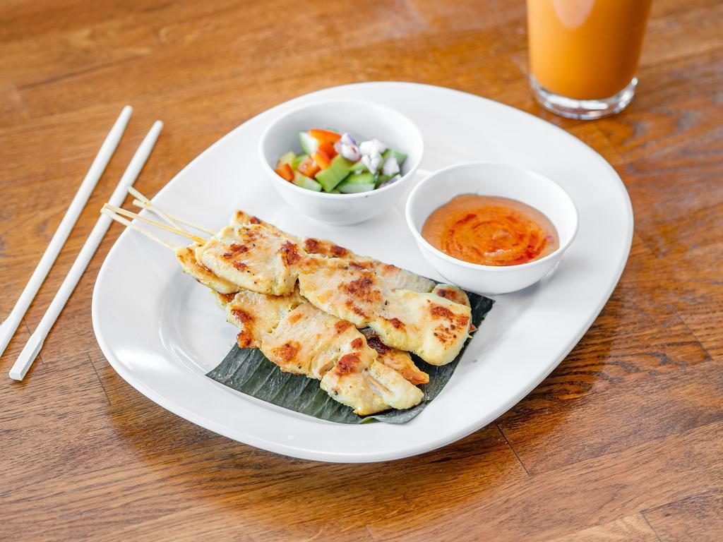 Chicken Satay · Perfection grilled chicken skewers served with peanut sauce and cucumber salad.