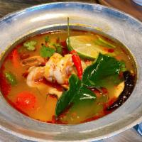 Tom Yum Goong · Hot and Sour soup harmonize broth Thai herbs, onion, mushroom, tomato, lemongrass, lime leav...