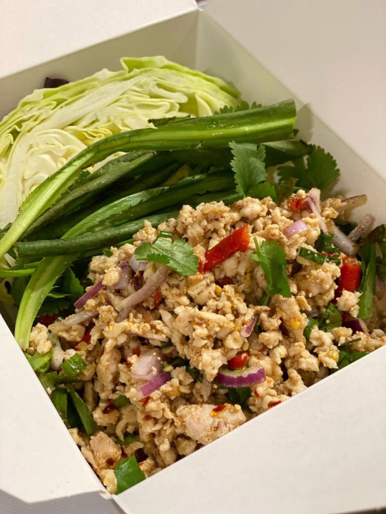 Chicken Larb  · Minced chicken tossed in spicy lime dressing, onions, culantro, shallot, and rice powder. Don’t forget sticky rice! (+$3)