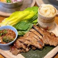 Moo Yang · Thai style grilled pork served with sticky rice and Jaew sauce.
