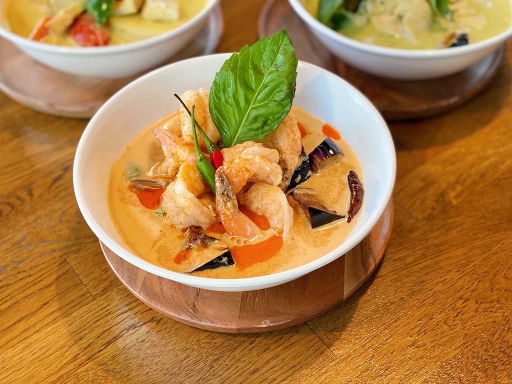 Red Curry  · A delightful balance of sweet and spicy flavors of the red curry paste with creamy coconut milk, eggplants, bamboo shoots, bell pepper, and basil leaves. Served with jasmin rice.
