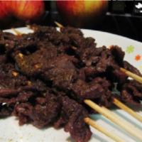 109. Satay Beef · 4 pieces. Marinated slices of beef on skewers.