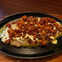 Nopal Ranchero · Grilled baby cactus topped with grated quesillo, mashed refried beans and mexican shredded s...