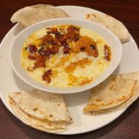 Queso Fundido · Melted Muenster cheese with spicy Mexican sausage, topped with pico de gallo and served with...
