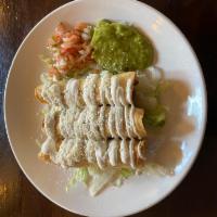 Tacos Dorados · Deep fried corn tortilla in a flute with your choice of filling topped with homemade salsa a...