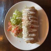 Tinga Burrito · Flour tortilla filled with beans, rice, Oaxaca cheese, and chicken tinga topped with tomato ...