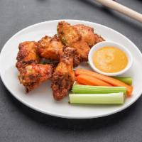 Chicken Wings · 1 lb. of wings tossed in choice of Buffalo, Asian Sriracha, or bourbon maple bacon.