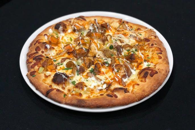 Buffalo Chicken Pizza · Grilled Chicken, Buffalo Sauce, Fresh Mozzarella, Caramelized
Onions, Diced Celery with a Ranch Drizzle.