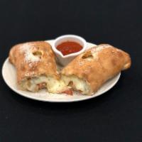 Tuscan Special Stromboli · Pepperoni, sausage, meatballs, mozzarella and a side of house sauce.