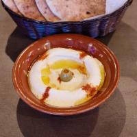Hummus · A puree of chickpeas, blended with tahini, garlic and fresh lemon juice. Topped with olive o...