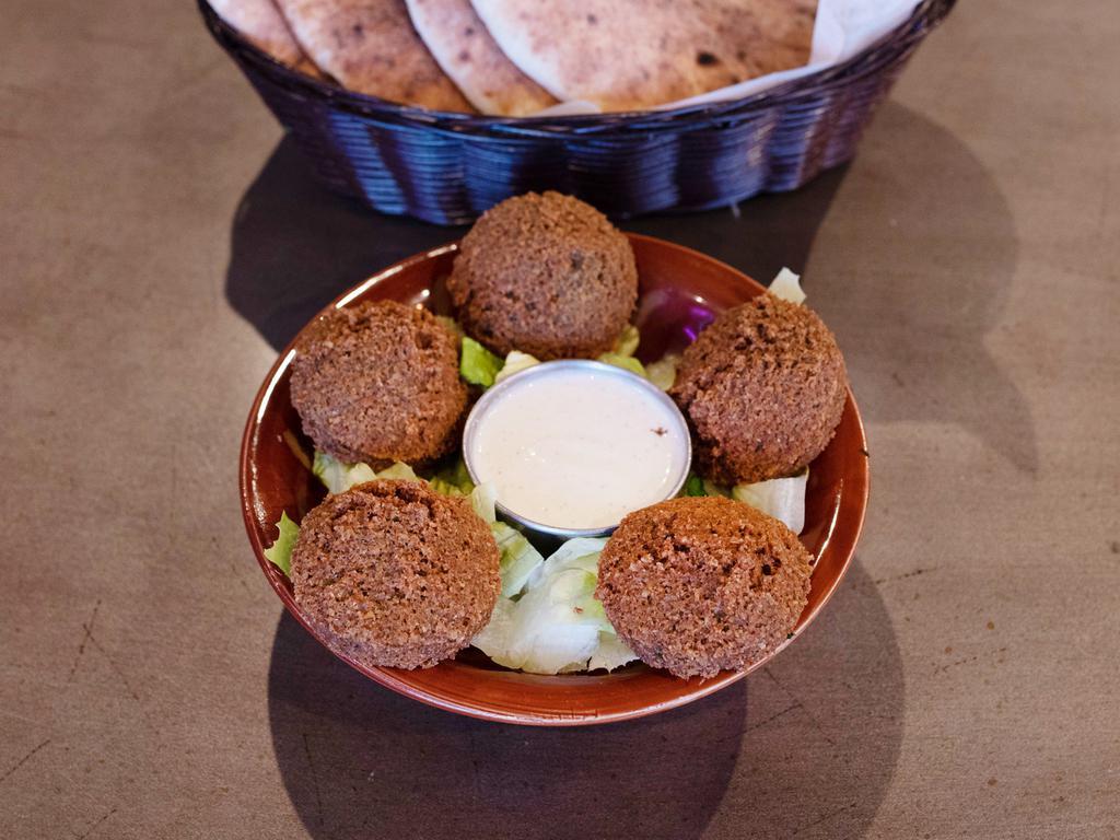 Falafelĺ · Falafel patties served with a tahini sauce and lettuce.