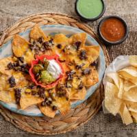 Fajita Nachos · Your choice of beef, chicken, or combo fajita, served with refried beans, melted cheese, gua...