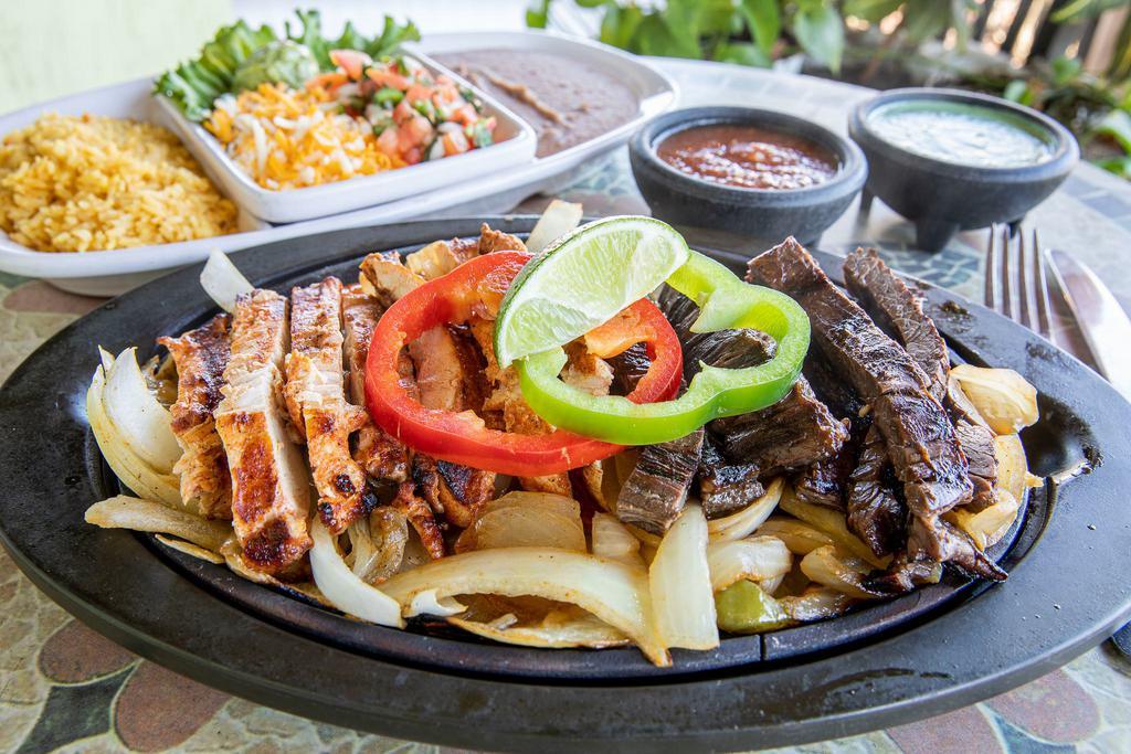 Combo Fajitas for 1 · A combination of select top-grade skirt steak, and grilled chicken breast served with your choice of rice and beans, guacamole, pico, grated cheese and fresh corn or flour tortillas.