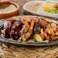 Ivan's Special Specialty · 4 oz. of fajita combo, 2 shrimp brochette, 2 BBQ ribs and pieces of sausage served with guac...